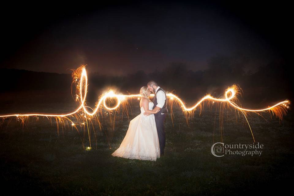 Light painting as newlyweds kiss