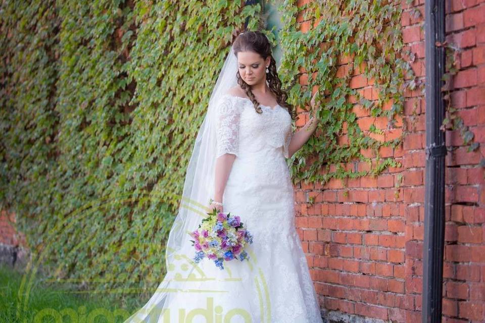 Bride by the brick wall