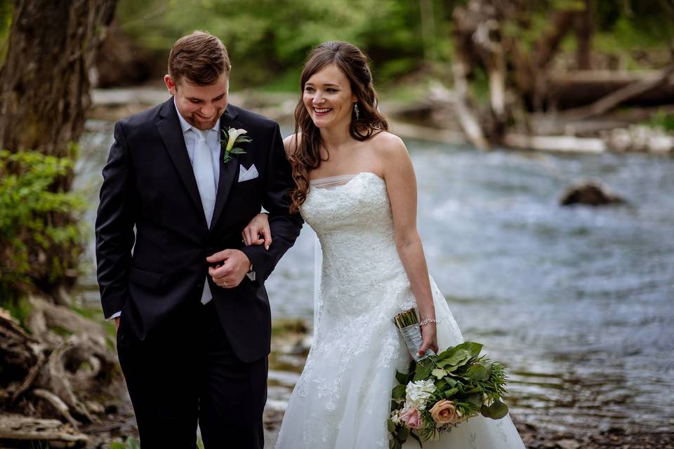 Bride and groom by the water