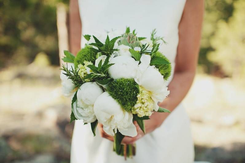 Bride and bridesmaid holding bouquets