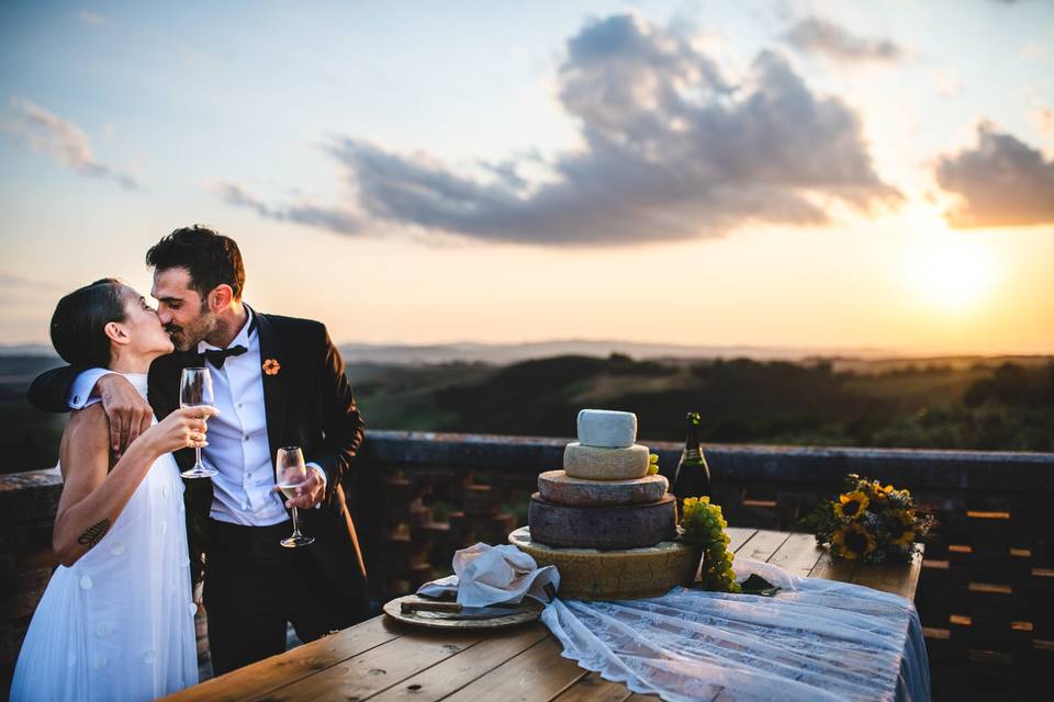 Cutting cake at the sunset
