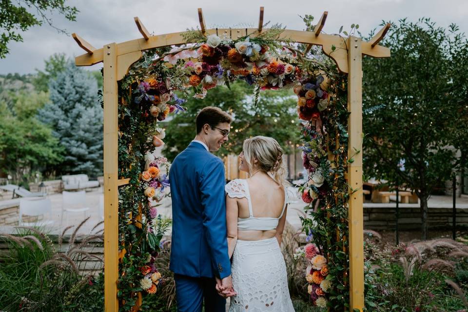 Happy couple beneath arbor