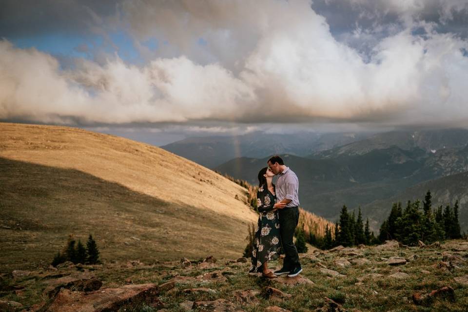 Couple embrace during rainbow