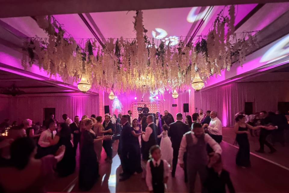 Packed Wedding Dance Floor with Pink Uplighting