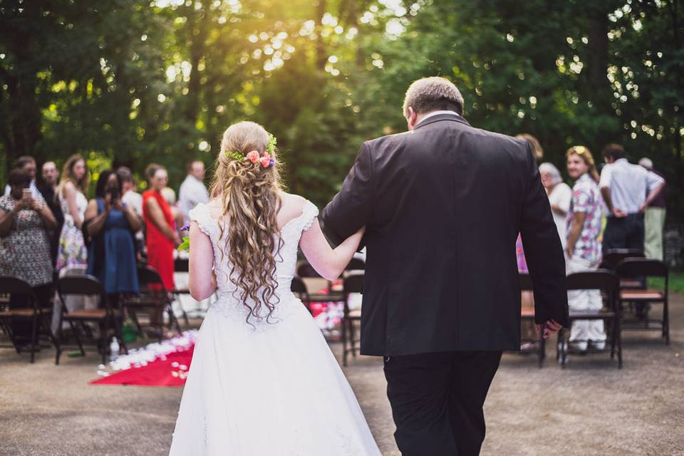 Bride being walked down the aisle