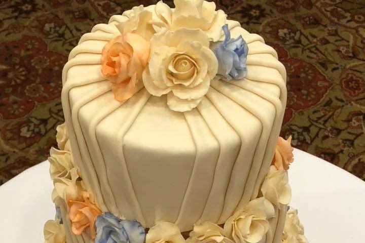 Fondant Pleated Cake with Sugar Flower Roses.  The pale blue and orange is school colors of University of Virginia were couple attended and were married.