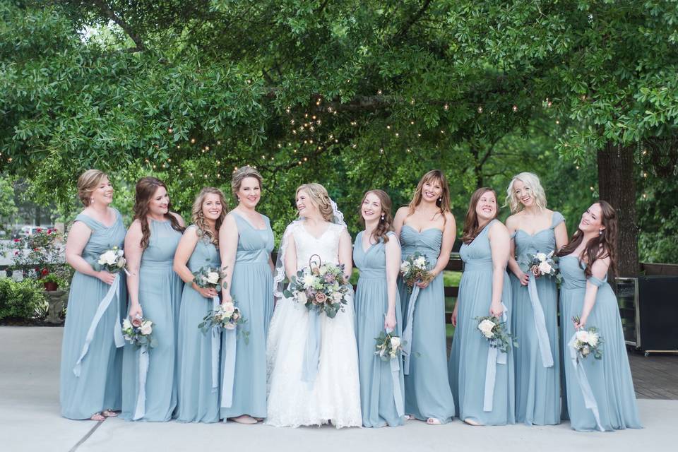 The bride and her bridesmaid holding bouquets