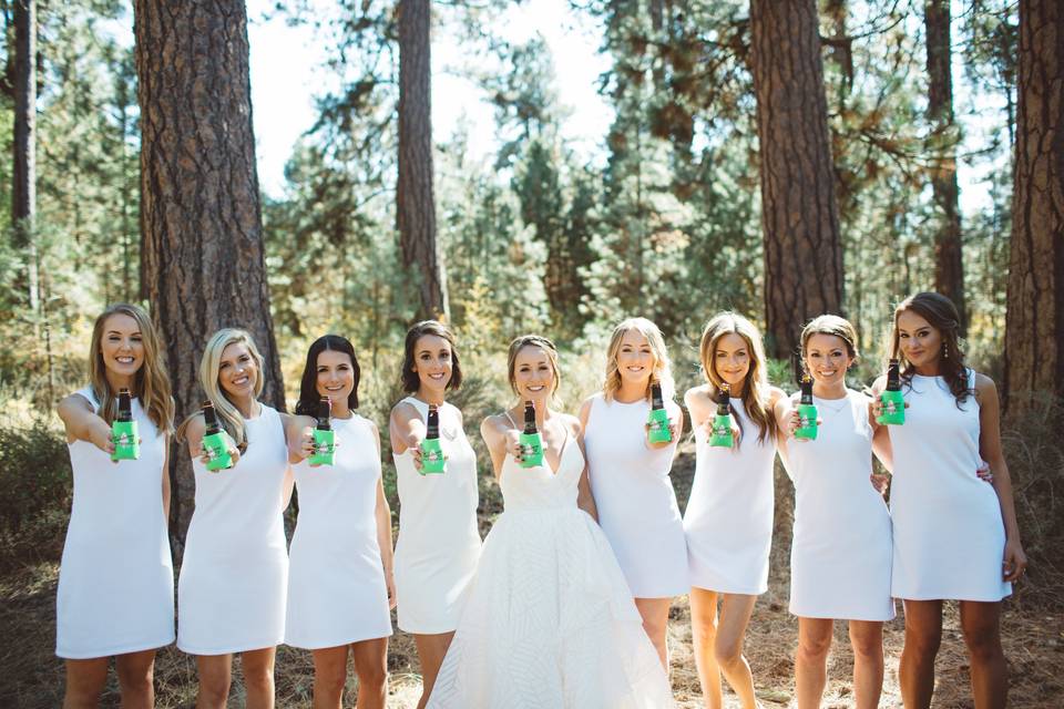 Newlyweds with wedding attendants in white