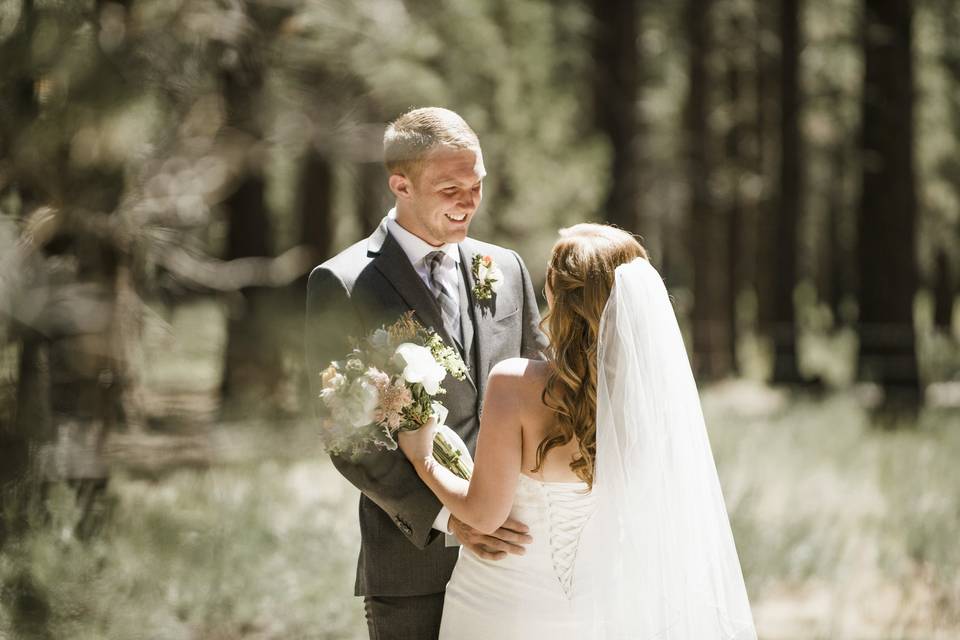 The newlyweds smiling at each other