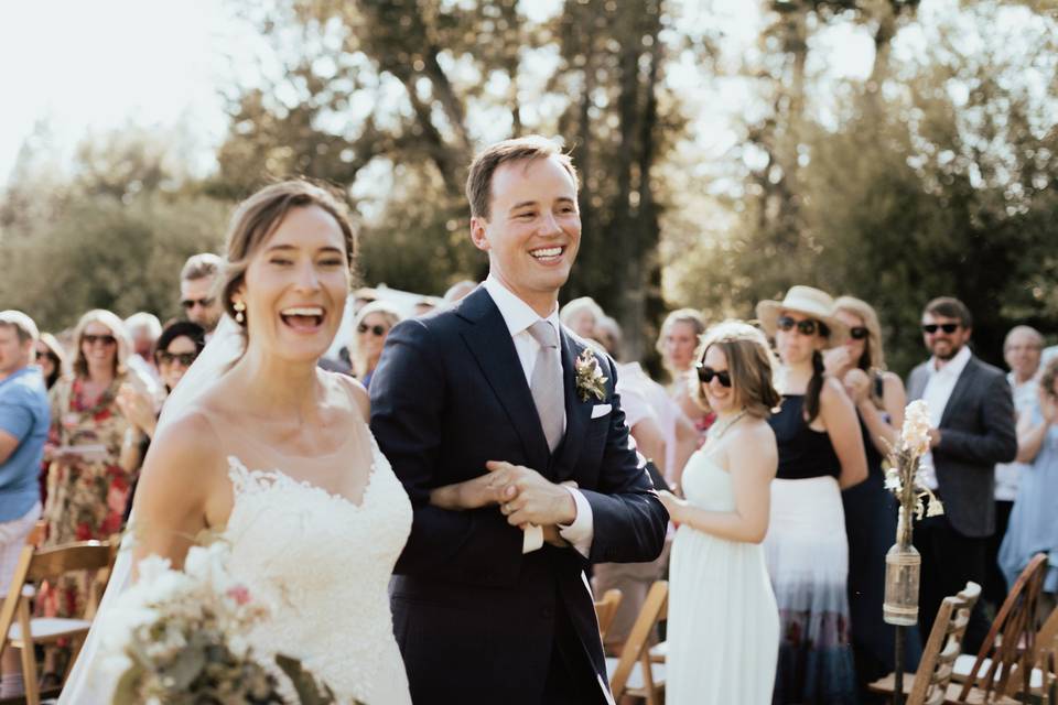 The newlyweds smiling at each other