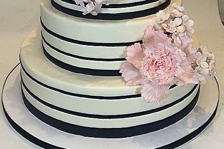 Double happiness gold accented wedding cake with blush roses and phalaemopsis orchids