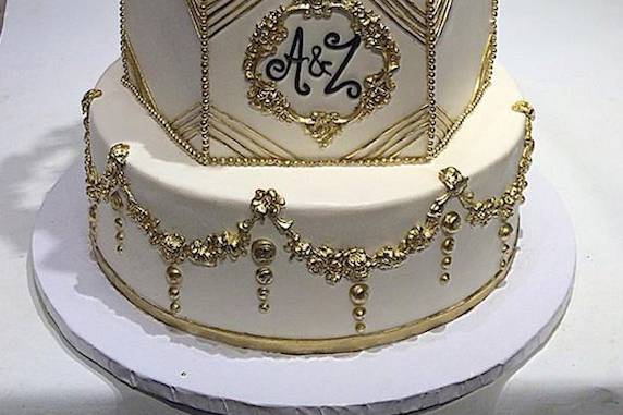 Monogram gold and blush pink wedding cake with customized art deco design