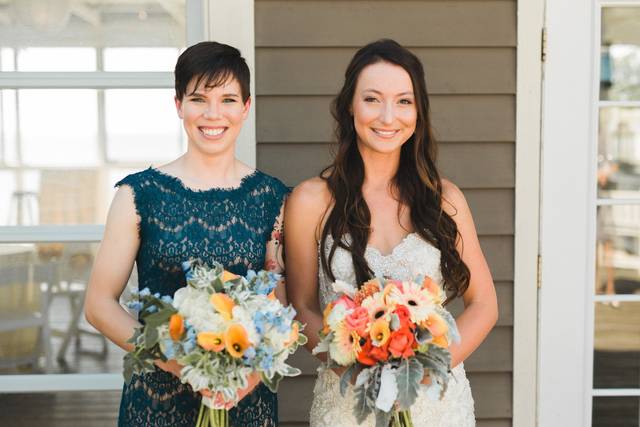 Bride and bridesmaid holding bouquet