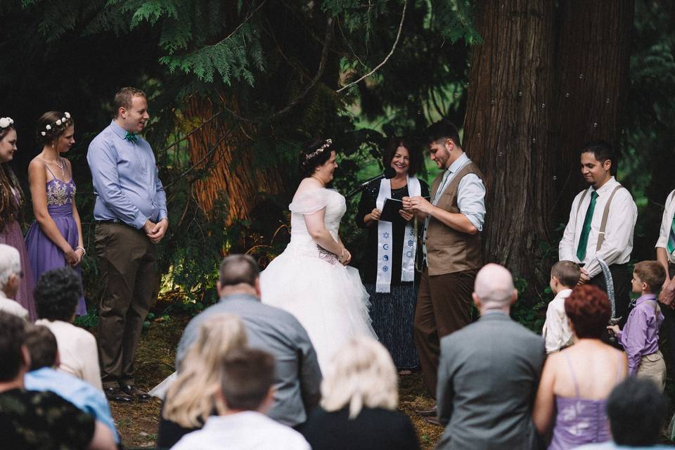 She is Pagan, he is Christian and we happily blended their different beliefs as the background to their celebration of their perfect love!  Their wedding was held in the horse pasture that she played in as she grew into a woman.  There was a touch of Star Wars in their theme!