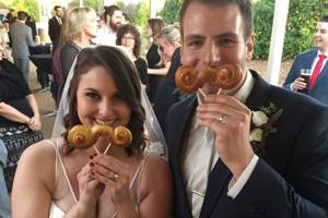 Newlyweds with their mustache pretzels