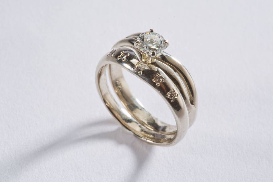 Carly's Bridal Celebratory Ring:  $4,300.00-$9,900.00
This ring has a story behind it.  It took over 30 years to design.  Starting with the eternal romantic proposing to his true love with his simple Gold ring design with one diamond.  She said 