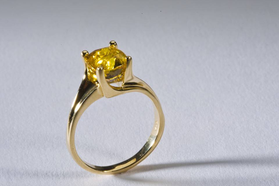 14k Gold Ladies Yellow Sapphire:  $2,950.00
The soft line of this 14k Yellow Gold Band holds a spectacular Yellow Sapphire in place.  No need for a setting or bezel.