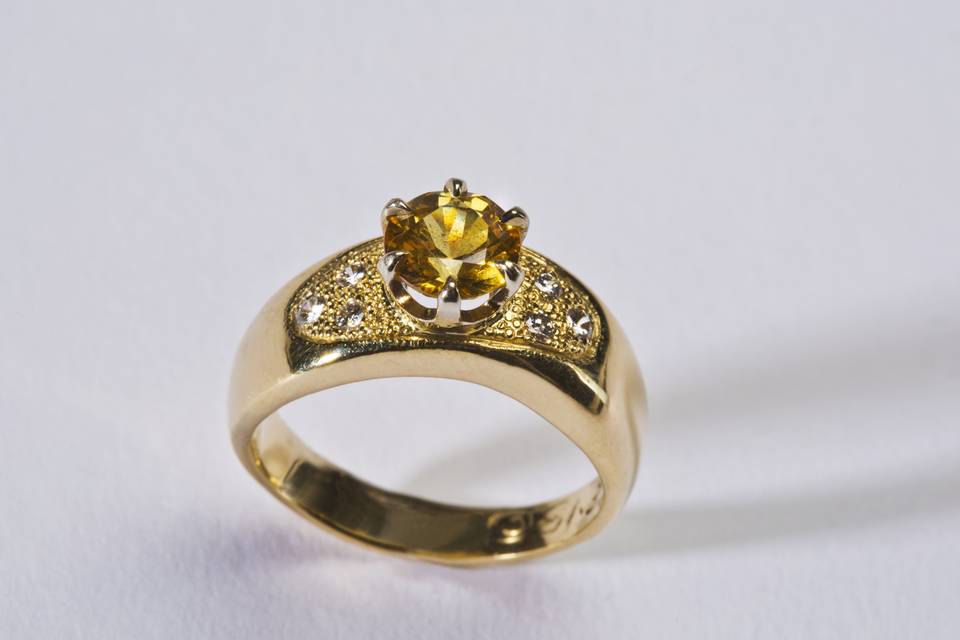 14k Gold Ladies Yellow Sapphire:  $2,950.00
The soft line of this 14k Yellow Gold Band holds a spectacular Yellow Sapphire in place.  No need for a setting or bezel.