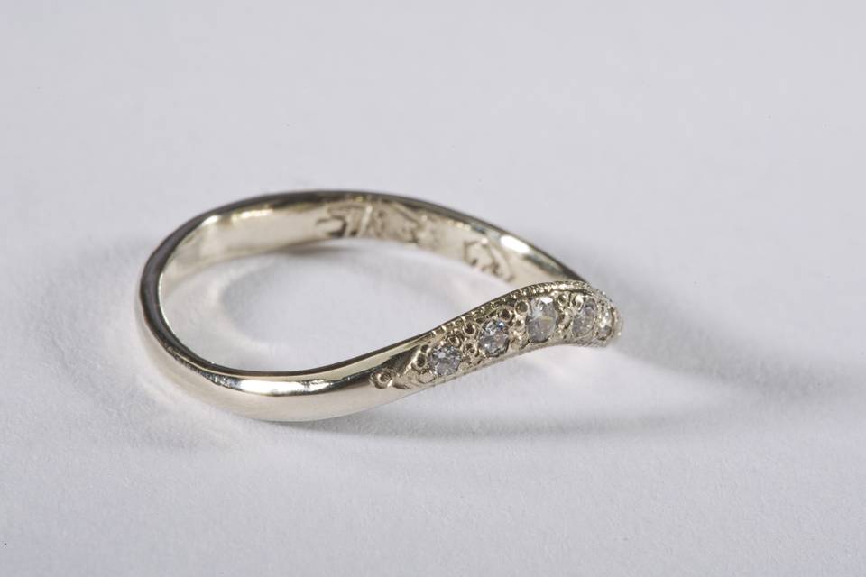 White Gold Band Diamond Melee:  $875.00
Diamond curved Wedding Band elegant hand engraved millgrain, accented with a melee of 5 diamonds, handmade 14k white gold.  The diamonds are comprised of the following sizes: one 2.0mm, two 1.7 mm and two 1.5 mm.
3.0 mm width on ring top at widest point