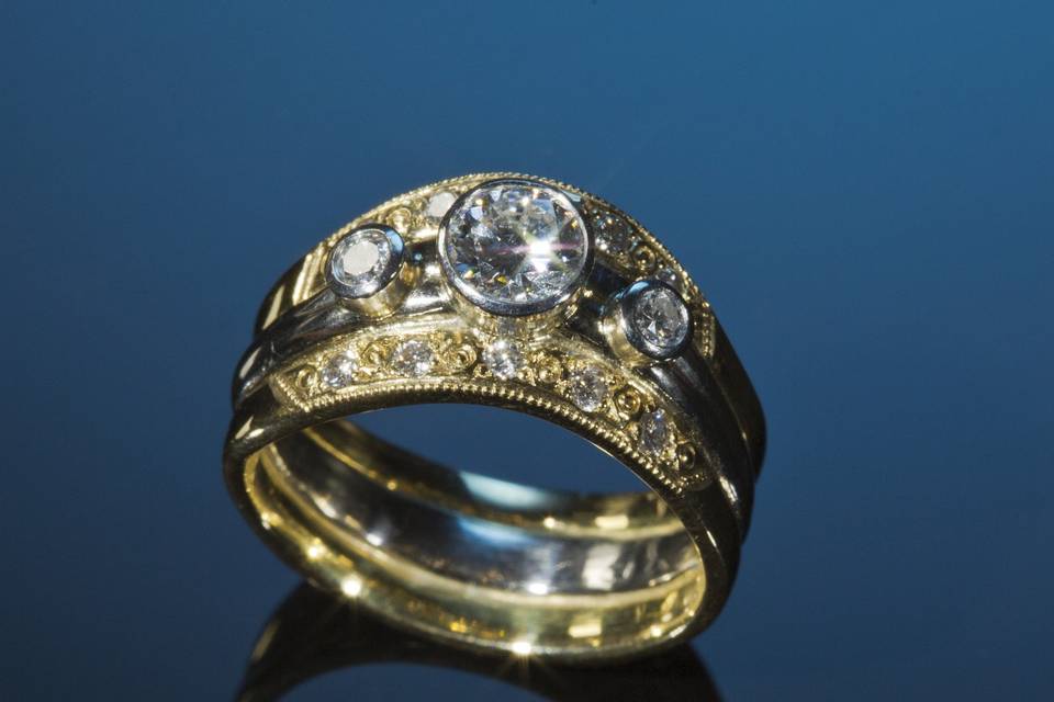 Platinum Ring Set:  $15,000.00-$17,900.00
This Ring Set starts with an Engagement Ring, Platinum Band with 3 Big Brilliant Diamonds.  Center stone is 1.04ct. left side. 57ct. right side .54ct. Flanked by two 18K Gold Bands Beautifully Milgrained and Bead Set with 5) .015ct.  Diamonds each band, both bands = .13ct. TW. All 3 Bands:  A Total Diamond Weight of 2.28ct.  This particular Ring is one of a kind.  Ready to ship at a 8 1/2 size with your Custom Worded Plaque Confirmation!  Additional shipping time with size change, down size only on this ring!  Can be remade with your ring size and 3 Diamonds of your choice.