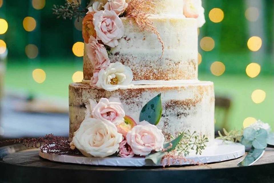 Semi-naked cake with cascading blooms