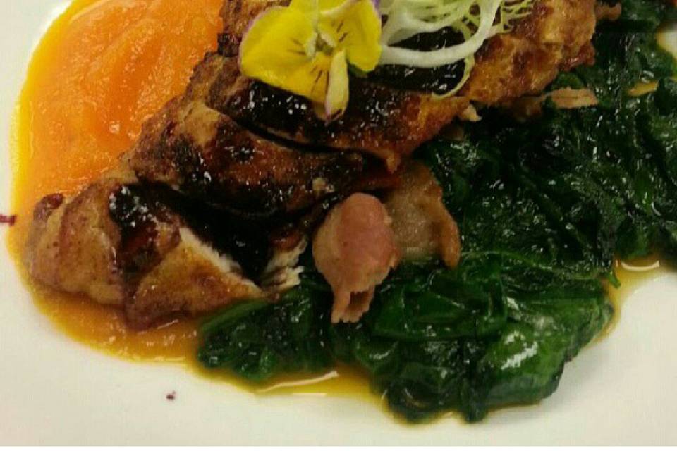 Pan seared chicken breast with a puree of carrots and baby spinach sautéed with bacon