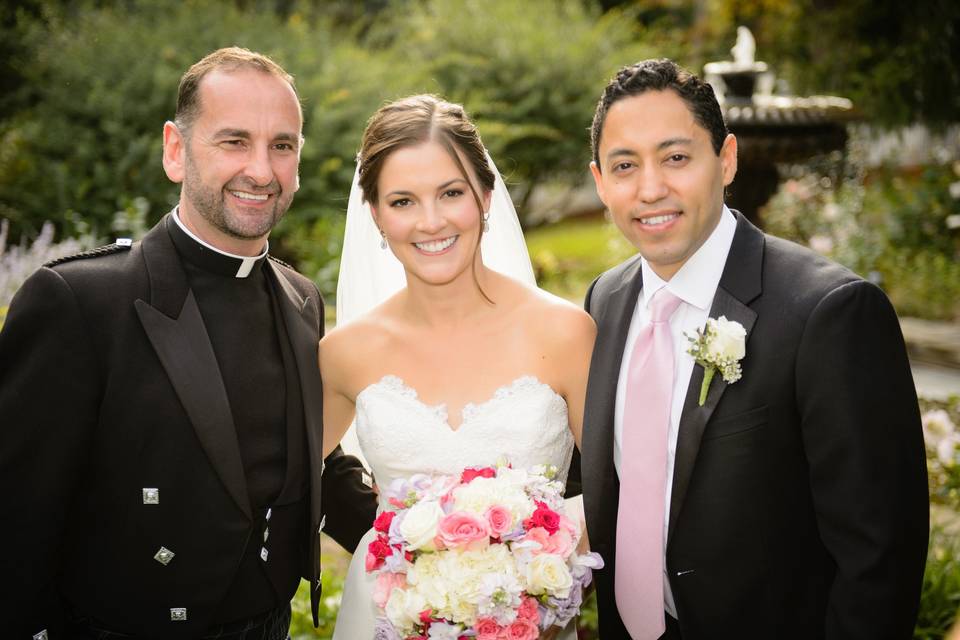 happy newlyweds with officiant