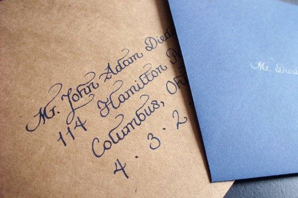 Kraft outer envelopes with navy calligraphy with navy inner envelopes with white calligraphy.