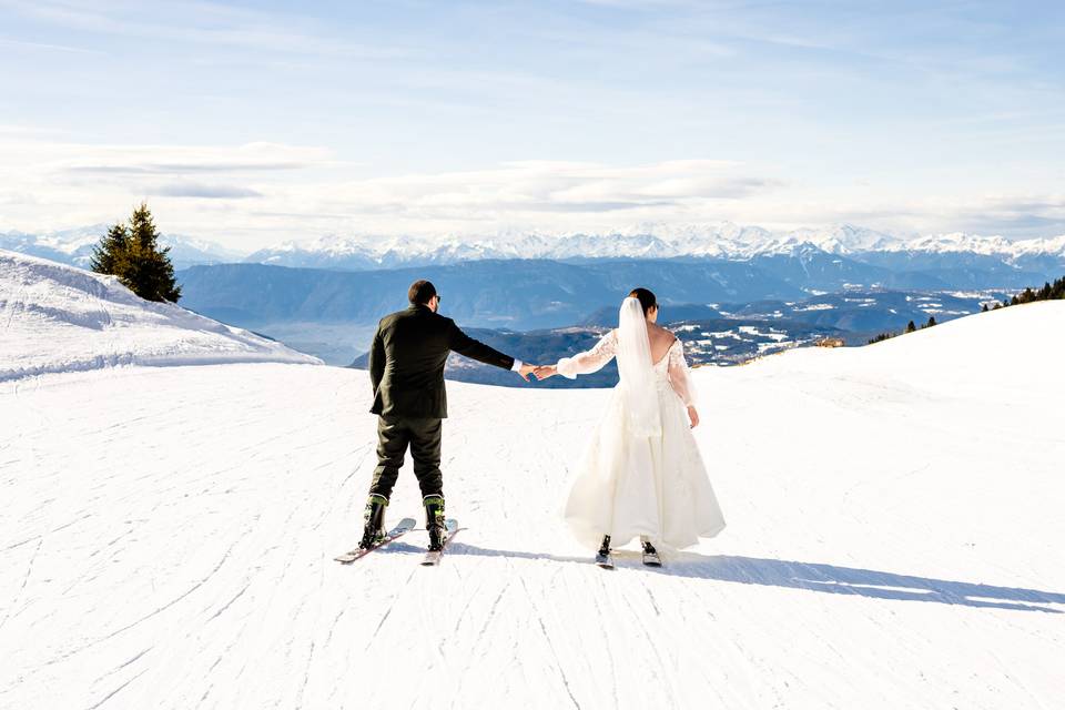 Newlywed skiing together hands