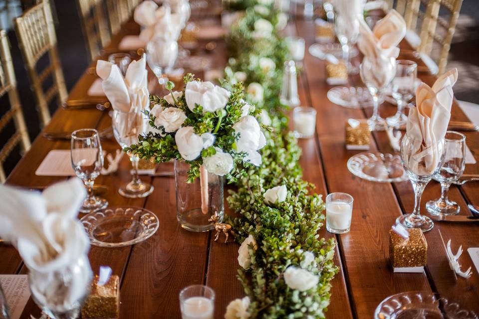Table setting with candle and floral centerpiece