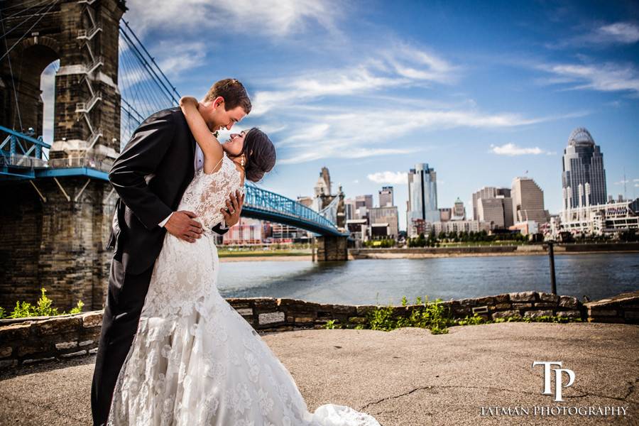 Couple embracing by the bridge - Tatman Photography