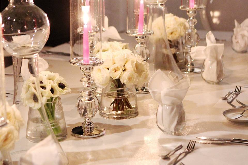 Table setting with candle and flower centerpiece