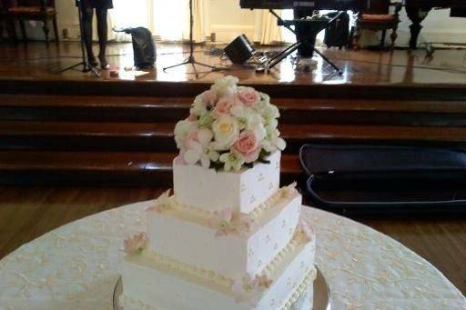 White wedding cake with pastel flowers