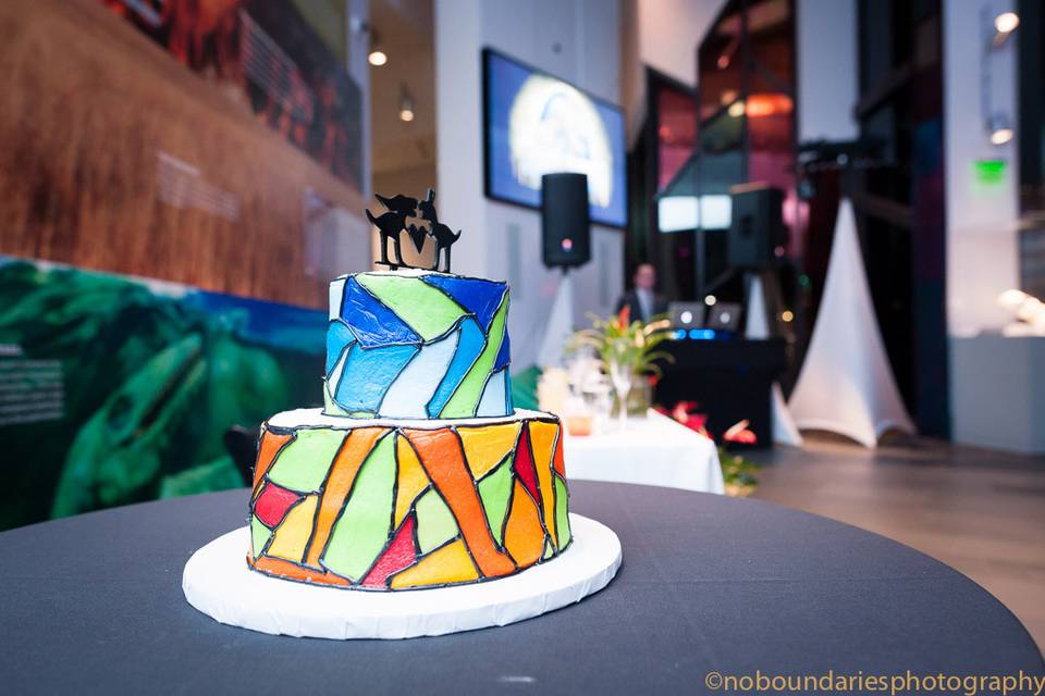 Designed to mimic our beautiful and unique windows, this cake is complete with a Mr. and Mrs. Dinosaur cake topper to reflect the them of the wedding.