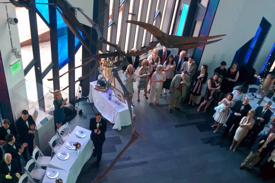 The couple shares their first dance in the Great Hall right under the Pterodactyls with all their friends and family around them.