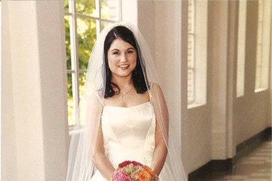 Bride posing while holding bouquet