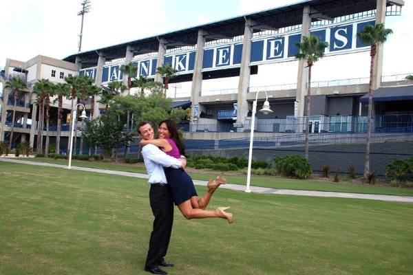 Marisa and Jeff having fun with their photo shoot on stadium grounds