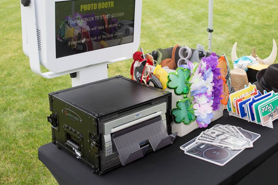 Outdoor open air photo booth setup under a canopy