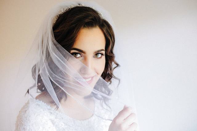 Bride hiding behind her veil