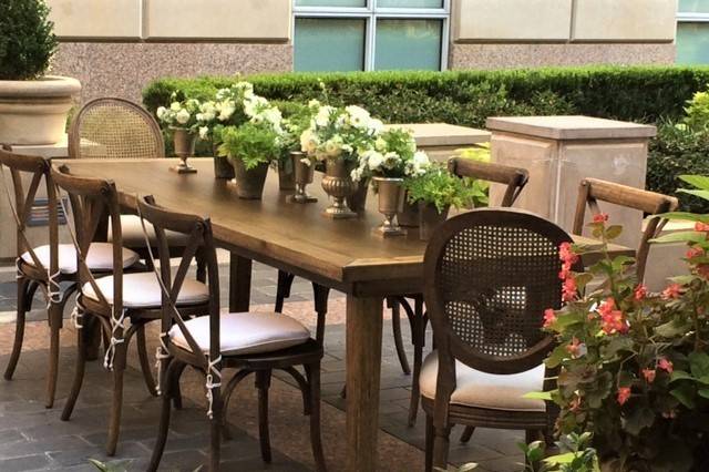 Natural Wood Farm Table, Cane Back Louis Chairs, X Back Pilgrim Chairs on the patio.