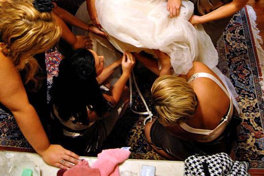 Bridesmaids helping the bride