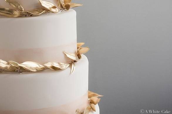 White cake with gold leaves