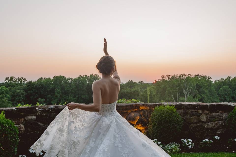 Bride twirling at sunset