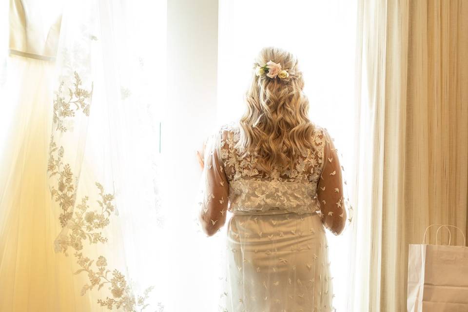 Bride looking out window