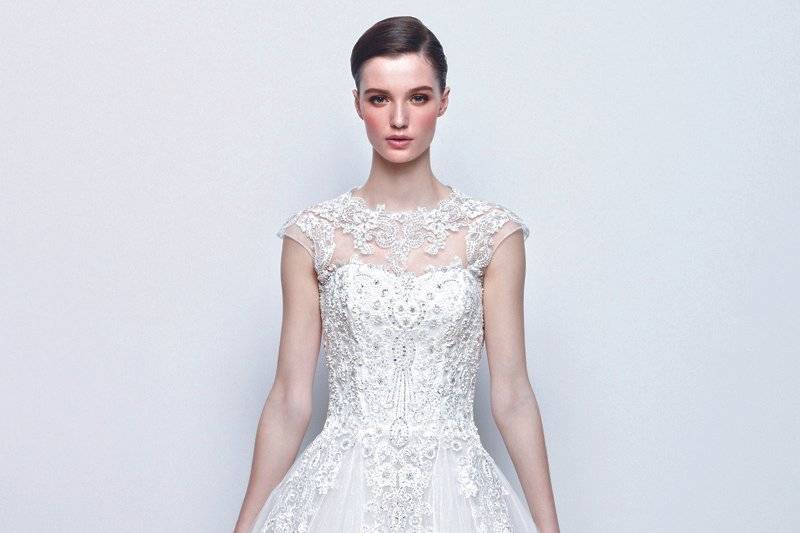 IVONNE
Sweetheart A-line gown in tulle with intricate embroidery and an illusion lace bateau neck with cap sleeves.
