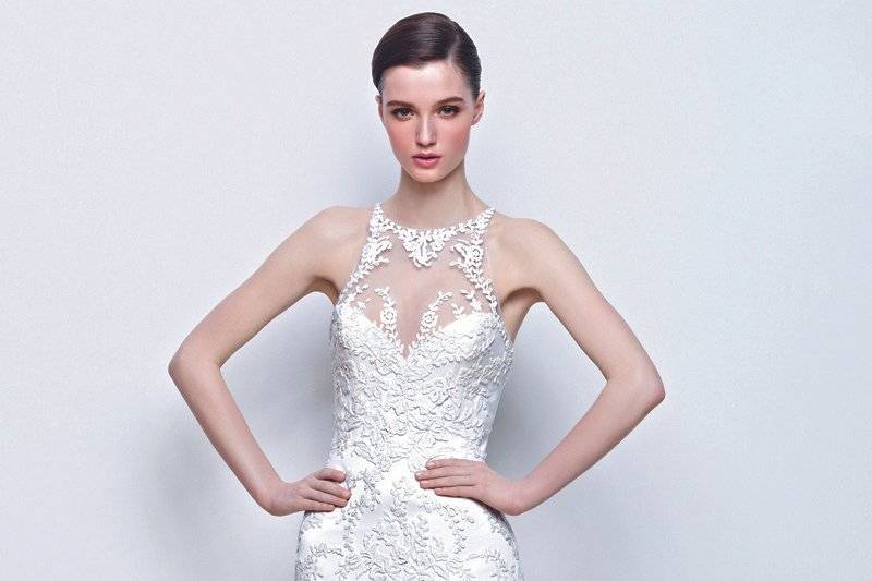 ISLA
This form-fitting gown has a high illusion neckline covered in white floral appliqués, and adorned illusion back .