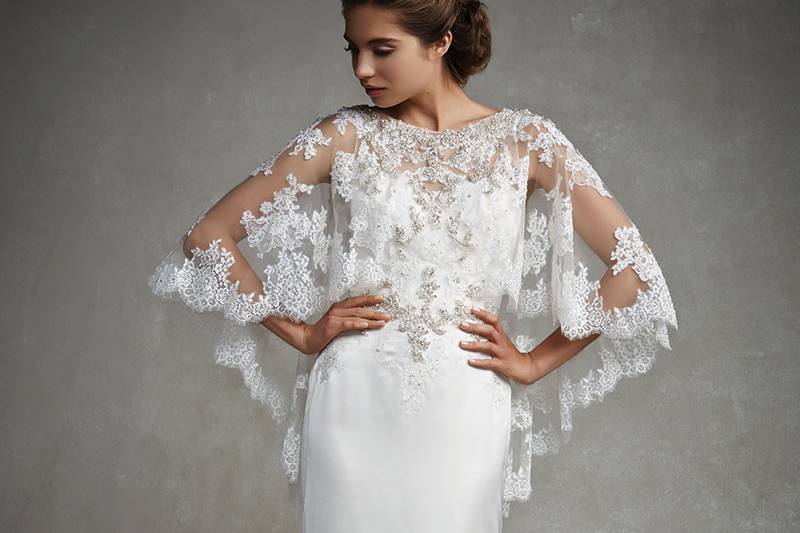 Enzoani Janice
<br>Flowing layers of tulle on the A-line skirt, with soft sweetheart neckline and ruched bodice embellished with beaded appliqués, create a vision of ethereal romance. An invisible zipper back completes the look.