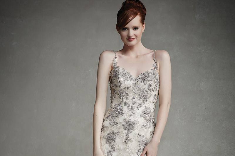 Enzoani Judy
<br> Romantic lace over a tulle mermaid skirt is enhanced with a classic sweetheart neckline, thin beaded spaghetti straps, and intricate beaded embroideries over lace appliqués on the bodice. Hem lace and a low back with invisible zipper beautifully complete the look.