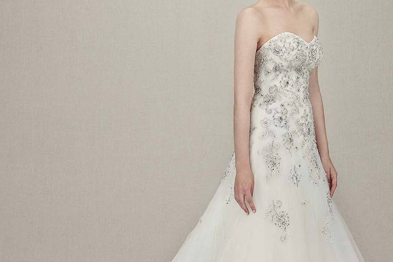 Style Kristie <br> Full-length mermaid gown features sweetheart neckline and bodice of softly gathered tulle extending down to tulle train with scattered beaded lace appliqués.