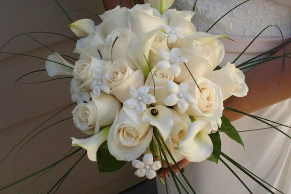 An elegant white bouquet of mini calla lilies, stephanotis and roses